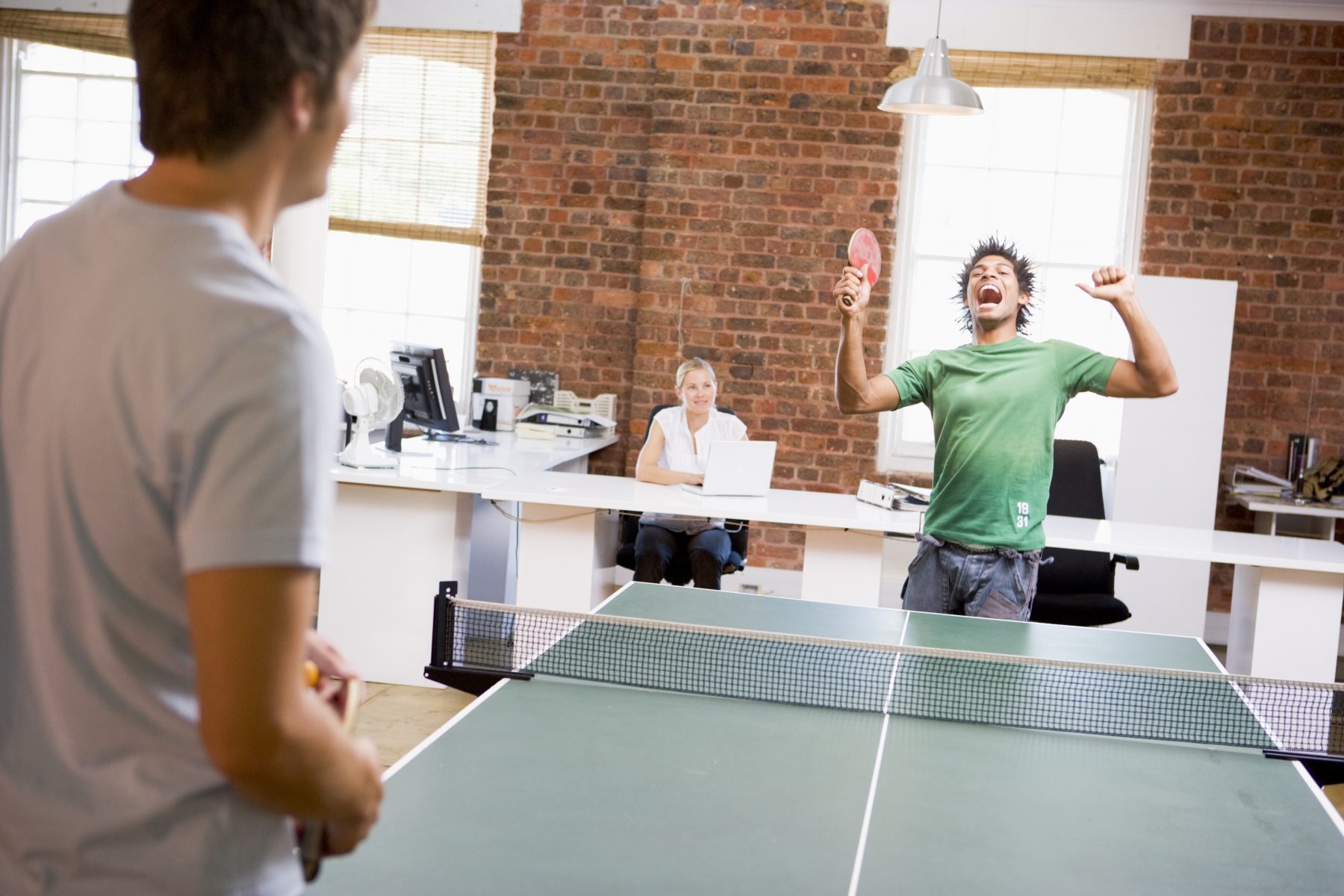 2130264-two-men-in-office-space-playing-ping-pong