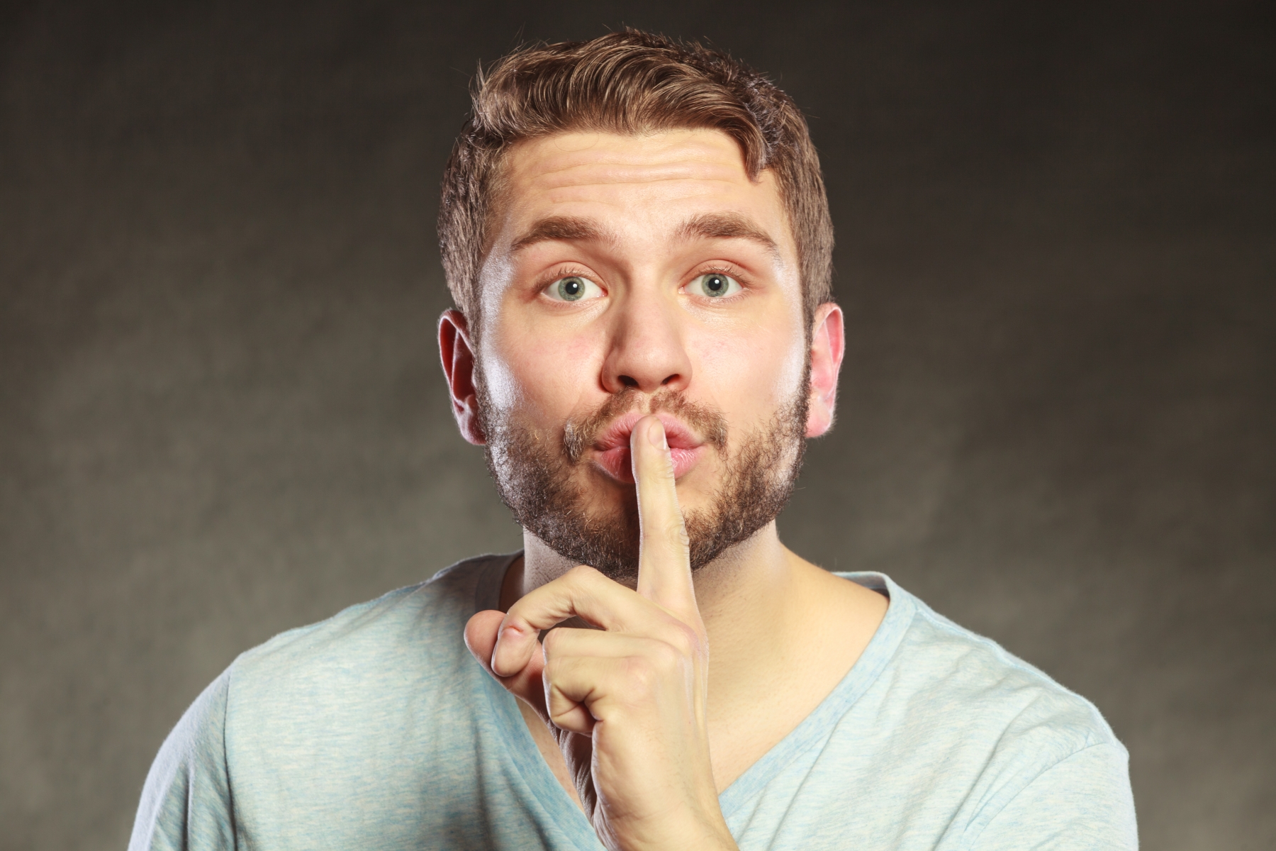 14597483-man-with-finger-on-lips-showing-silence-gesture